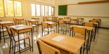 School empty classroom with test sheet or exams paper on desks chair wood and greenboard at high school thailand, education test concept